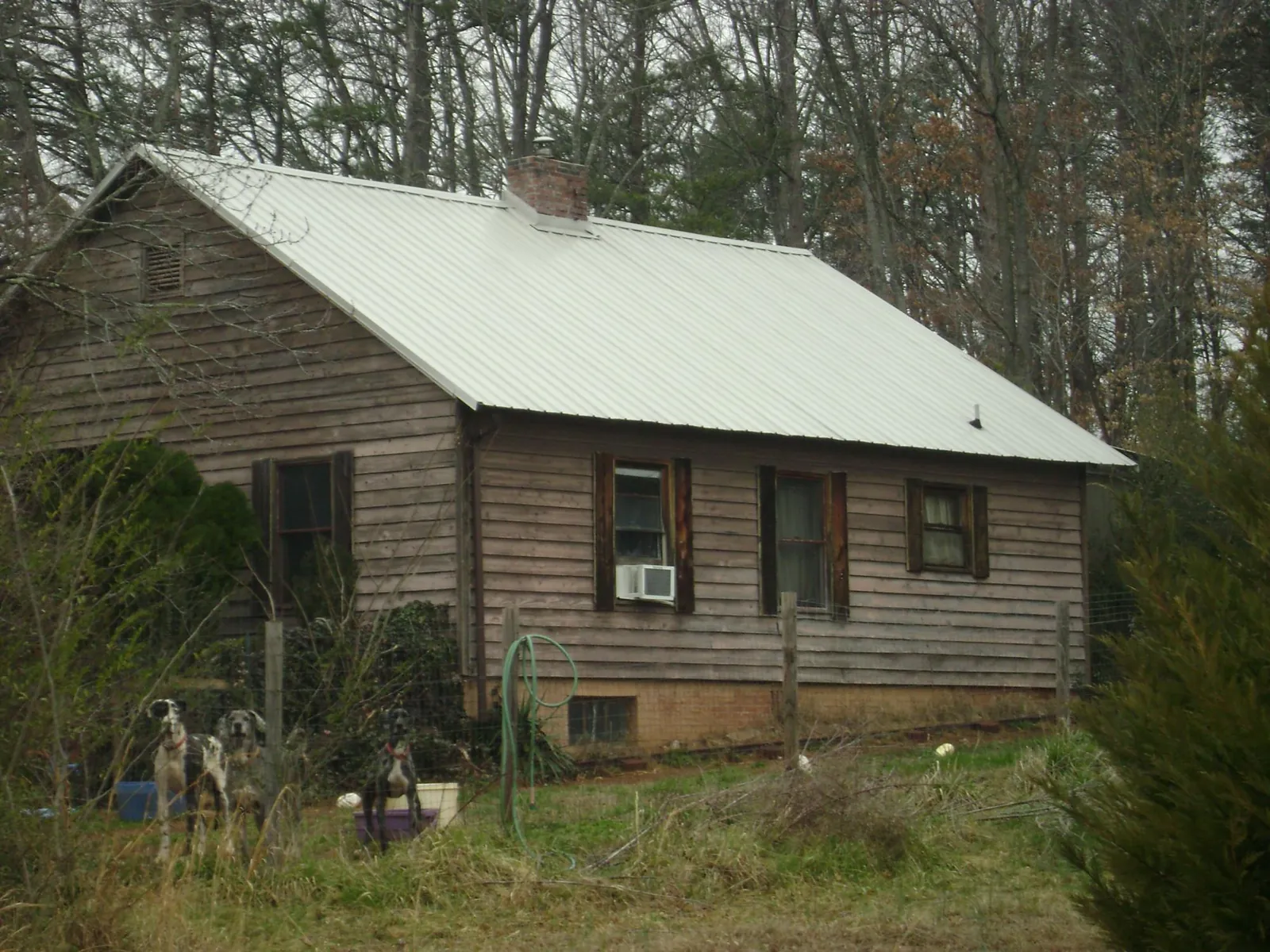 White metal roof on an old wood sided farmhouse, from a Metal Roof Installation job in Coralville